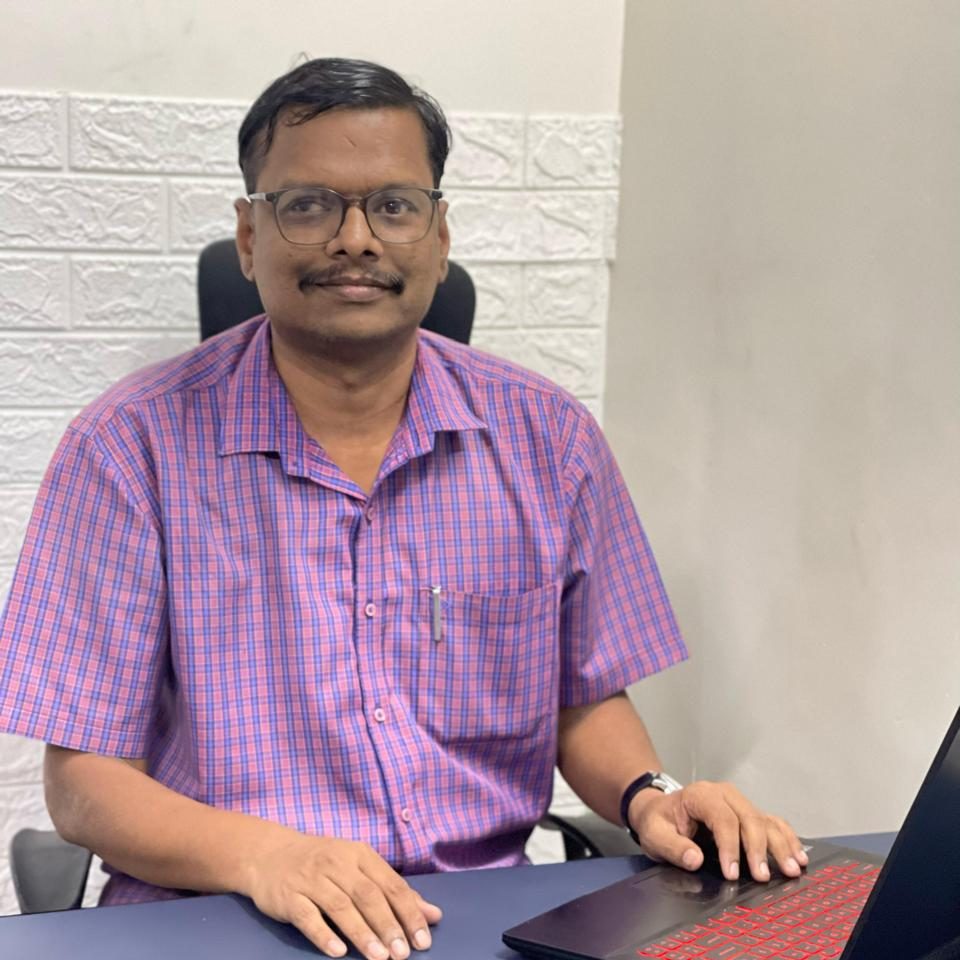 Balaji K, CTO of Here and Now AI, working at a digital workstation